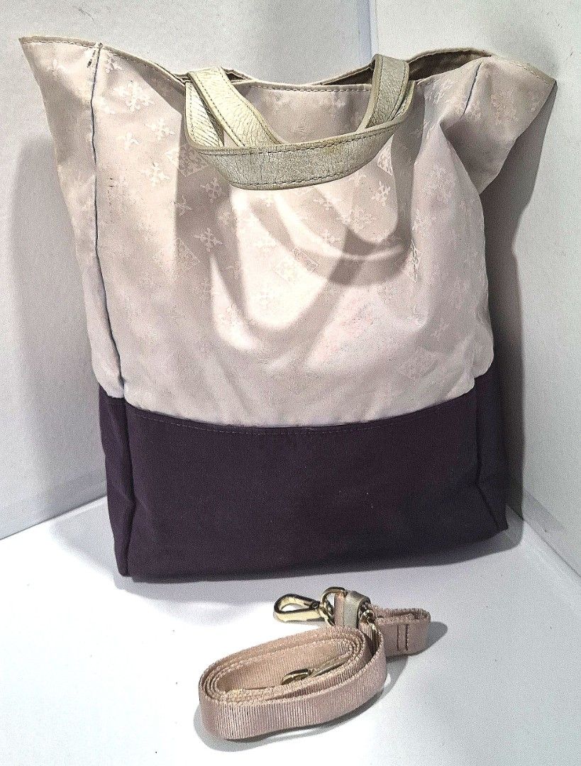 Russet Candle 2-way tote bag (Category: Luxury Bags & Wallets) located in Antipolo. Submitted by saribymonica (Listing ID 1461494071, Image 1). Description: -Russet Candle 2-way tote bag featuring a light monogram upper section and a contrasting dark purple base. - Light purple tote bag - Dark purple base - Subtle patterned fabric on upper part - Gold-tone hardware on straps - Detachable shoulder strap included - Interior zippered pocket - Clean 