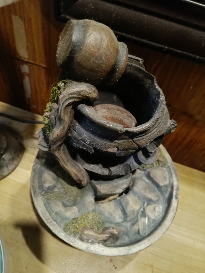 Rustic Tabletop Water Fountain (Category: Other Home Decor) located in Manila. Submitted by mecaart (Listing ID 1461411320, Image 2). Description: - Rustic broken pot design - Water flows down layers - Decorated with stones and mossy accents - Unique piece for home or garden - Adds a calming ambiance.