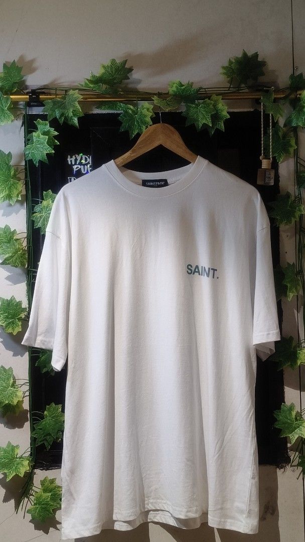 SAINT Original Garments T-shirt White (Category: Tshirts & Polo Shirts ) located in Manila. Submitted by moneyroll420 (Listing ID 1461473885, Image 1). Description: - Classic white t-shirt - Features 'SAINT' logo on the front - 'GENUINE SAINT Original Garments' graphic on the back - Comfortable and casual design - Ideal for everyday wear.