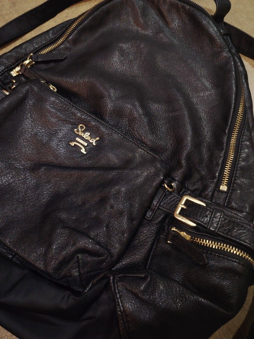 Salad Black Faux Leather Backpack Gold Hardware (Category: Backpacks) located in San Jose del Monte. Submitted by klowiboy (Listing ID 1461366409, Image 3). Description: - Brand: Salad - Material: Faux Leather - Color: Black - Hardware: Gold zippers and buckles - Features: Front zip pocket, adjustable straps - Style: Versatile, great for everyday or travel - Interior: Plenty of space Excellent Condition✅️ 10/10 Color Rate✅ Dimes: W15 L17 inches 9