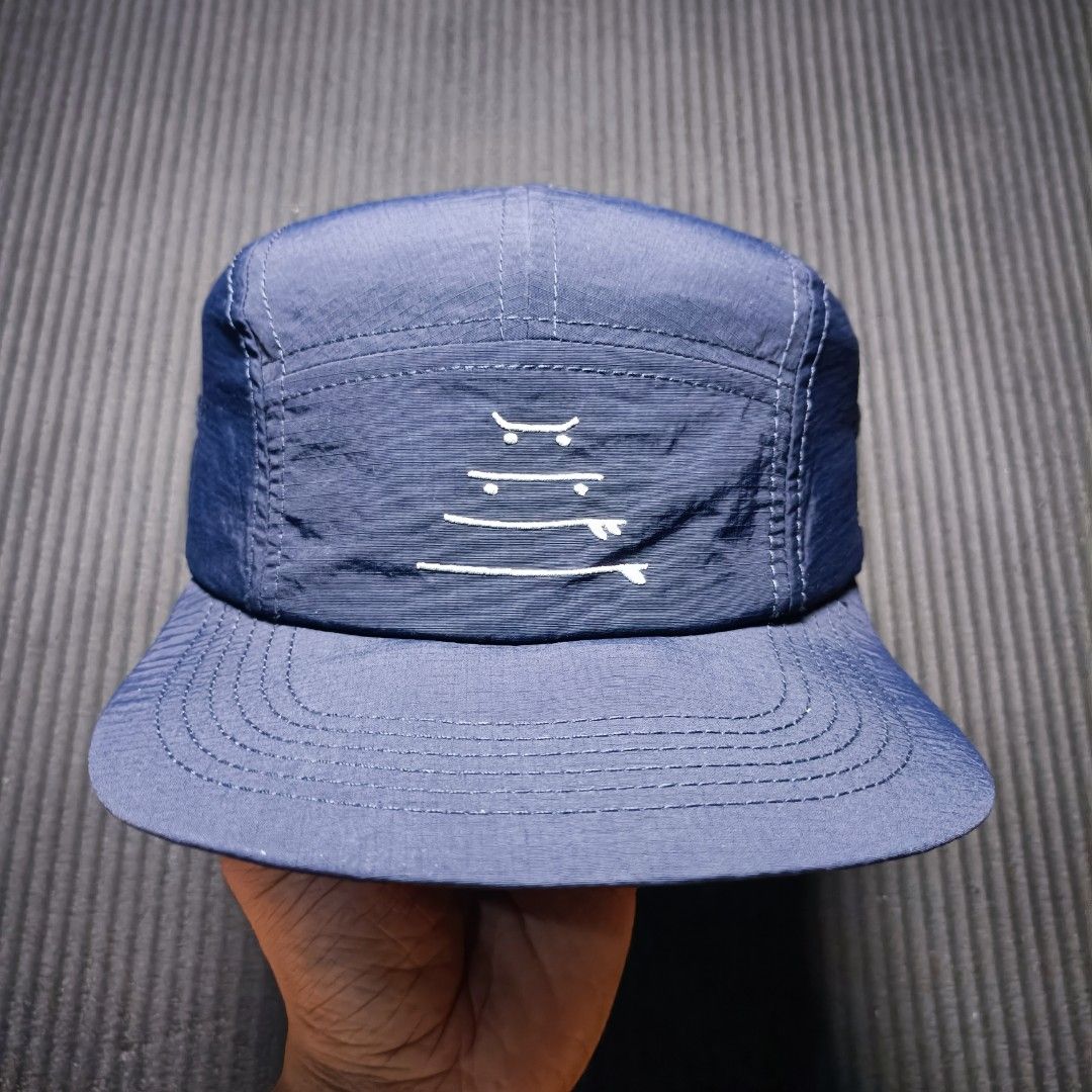 SANTOLOCO. Skate & surf apparel (Category: Caps & Hats) located in Manila. Submitted by nye.seller (Listing ID 1461494368, Image 1). Description: - Navy blue 5-panel cap - Brand: SANTOLOCO - Features a simple graphic design on the front - Adjustable strap at the back for a customized fit - Material: 100% Nylon - Ideal for everyday wear.