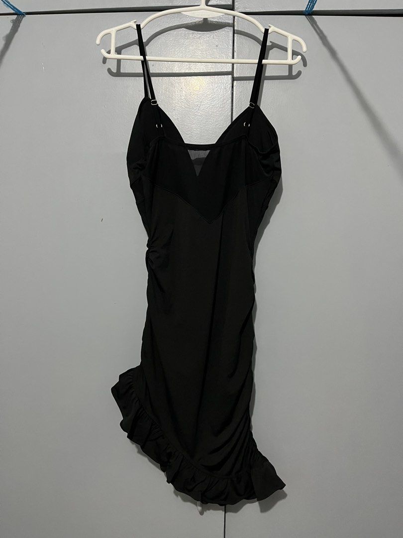 SBAFEE Black Ruched Ruffle Dress (Category: Dresses) located in Manila. Submitted by mae_meyn (Listing ID 1461450301, Image 3). Description: - Black spaghetti strap dress - Flattering V-neckline with sheer paneling detail - Ruching down the side for a fitted look - Ruffle hem for added flair - Small red SBAFEE logo tag - Ideal for a night out - NEEDS WASH - USED ONCE (photoshoot) Mode of Payment: Cash 💵 / GCash / Bank coming soon! Meetup: Sta An