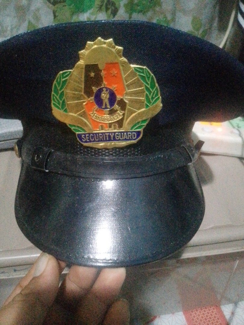 Security Guard Cap with Emblem (Category: Caps & Hats) located in Manila. Submitted by chollo24 (Listing ID 1461327235, Image 1). Description: - Black security guard cap - Features official emblem on the front - Adjustable strap for a comfortable fit - Breathable mesh lining inside - Ideal for security personnel or collectors.