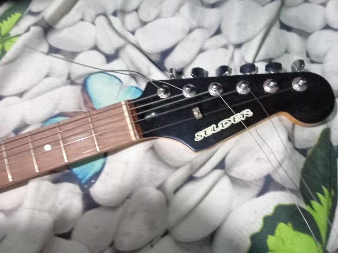 Selder Stratocaster Electric Guitar (Category: Musical Instruments) located in Caloocan City. Submitted by joshyjosh12345 (Listing ID 1461401238, Image 3). Description: SELLING: Selder Stratocaster Electric Guitar. Open for swaps with Iphones Minimally used and still in good condition. - Rosewood neck/fingerboard - Minimal scratches and signs of use - Minimally used - Electronics are still working properly and sound great - Good for beginners, st