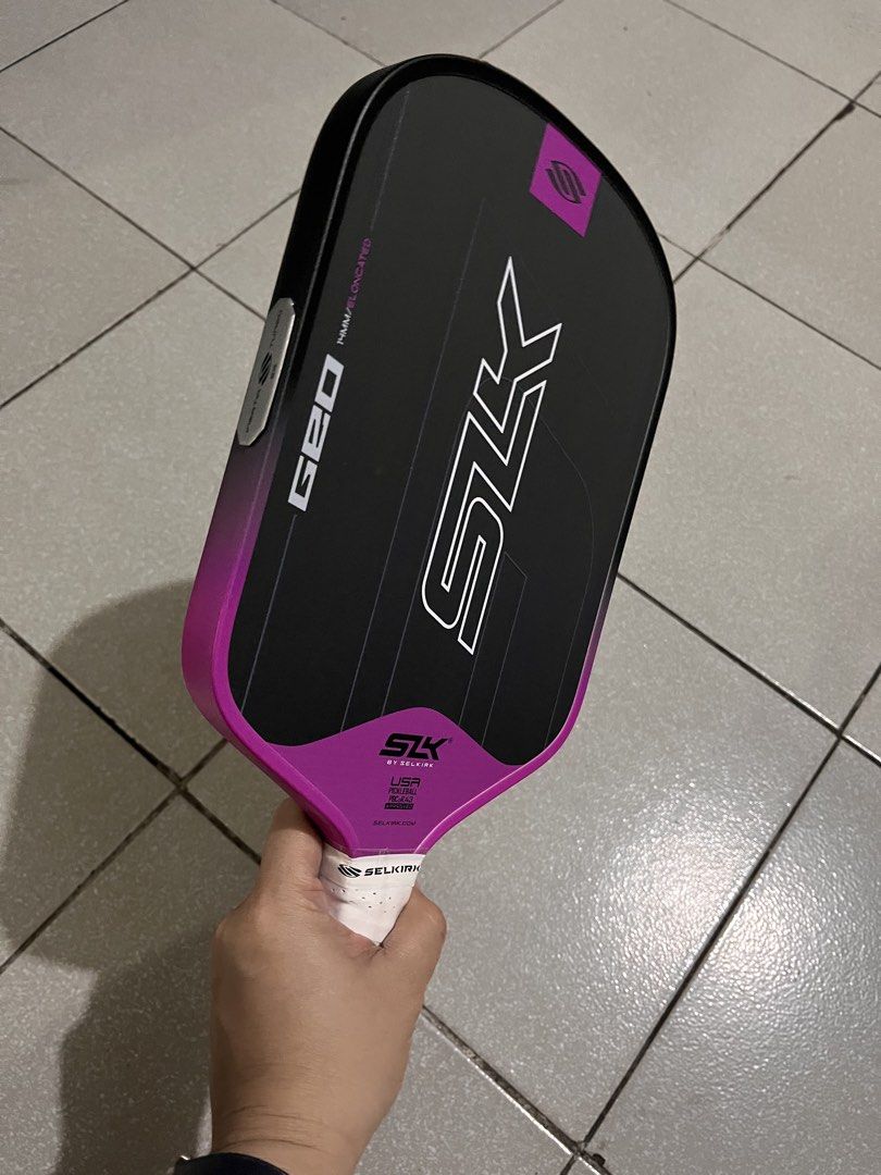 Selkirk SLK Geo Pickleball Paddle (Category: Racket and Ball Sports) located in Manila. Submitted by pickleball_paddles (Listing ID 1461355285, Image 2). Description: - Selkirk SLK Geo elongated pickleball paddle - Stylish black, pink, and green design - Comfortable white grip - Offers a balanced feel for versatile play - Perfect for your next pickleball match.