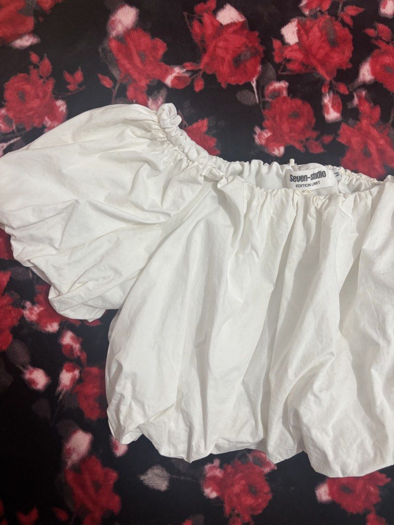 Seven Studio White Puff Sleeve Off-Shoulder Top (Category: Blouses) located in Cavite. Submitted by raf.nomnom (Listing ID 1461401648, Image 1). Description: - White puff sleeve top from Seven Studio - Off-shoulder design with elasticated neckline and hem - Short sleeves with gathered detail - Casual and chic style - Ideal for summer outfits.