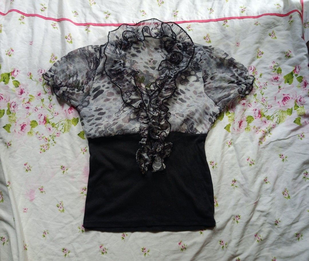 Sheer Ruffle Front Blouse with Black Bodice (Category: Blouses) located in Kalibo. Submitted by choirandoms (Listing ID 1461498729, Image 1). Description: - Sheer black and white patterned fabric - Ruffled front detail - Short puff sleeves - Black ribbed bottom section - Unique, funky print - Perfect for dressing up or down.