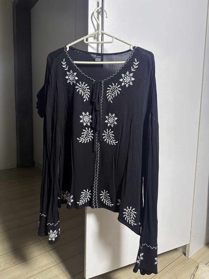 SHEIN Black Embroidered Long Sleeve Top (Category: Blouses) located in Pasig City. Submitted by iivyclutters (Listing ID 1461512404, Image 1). Description: - Black long sleeve top - White embroidery detail - Tie-neck feature - Embroidered cuffs - Versatile: pairs well with jeans or shorts - Comfortable and stylish for casual outings.