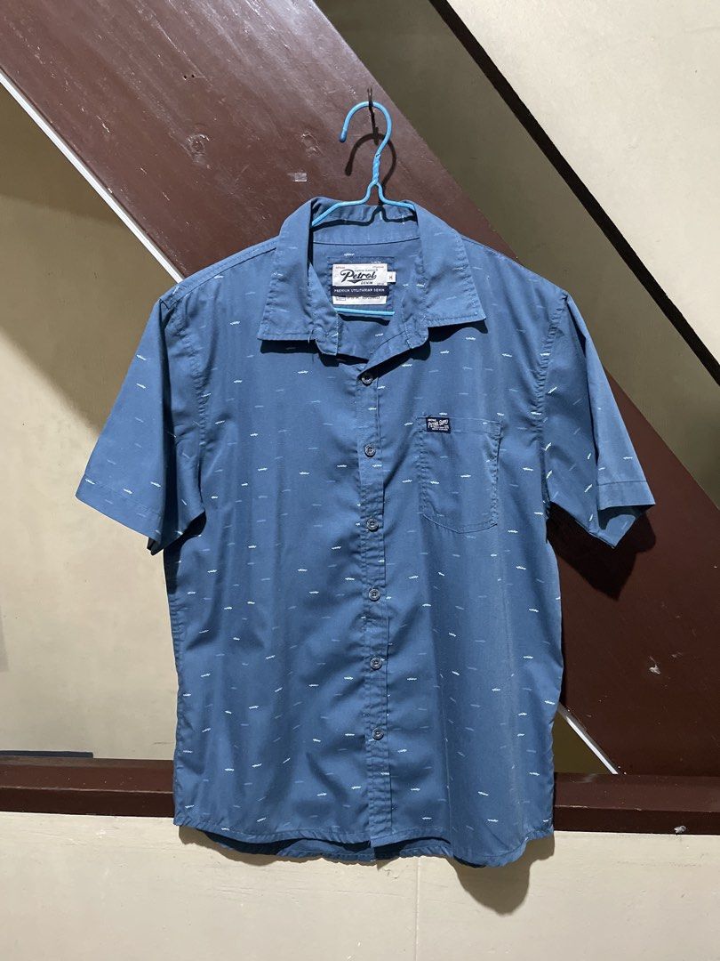 Short Sleeve Button Up Shirt Size M (Category: Tshirts & Polo Shirts ) located in Manila. Submitted by round_0000 (Listing ID 1461413239, Image 1). Description: - Brand: Petrol Industries - Style: Short sleeve button-up shirt - Color: Blue - Pattern: Subtle all-over white pattern - Features: Chest pocket - Occasion: Casual wear Actual product color may vary slightly from the photos shown. The seller will ship from Manila. Terms: 1. Shipping fee w