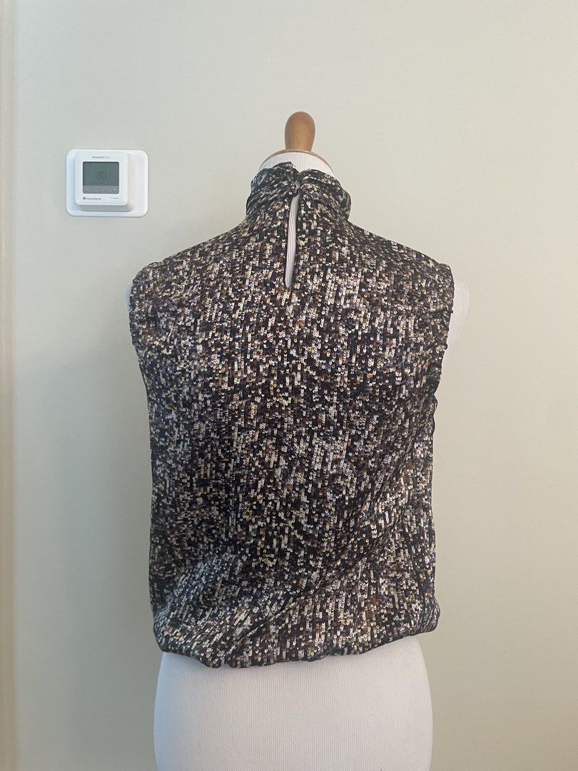 Sleeveless Mock Neck Top with Sequin-like Pattern D&G (Category: Sleeveless) located in Makati City. Submitted by cheapipie (Listing ID 1461407894, Image 3). Description: - Sleeveless mock neck top/ 100%Silk - Dark fabric with scattered sequin/bead-like pattern - Back closure - Ruched neckline detail - Versatile for dressing up or down.