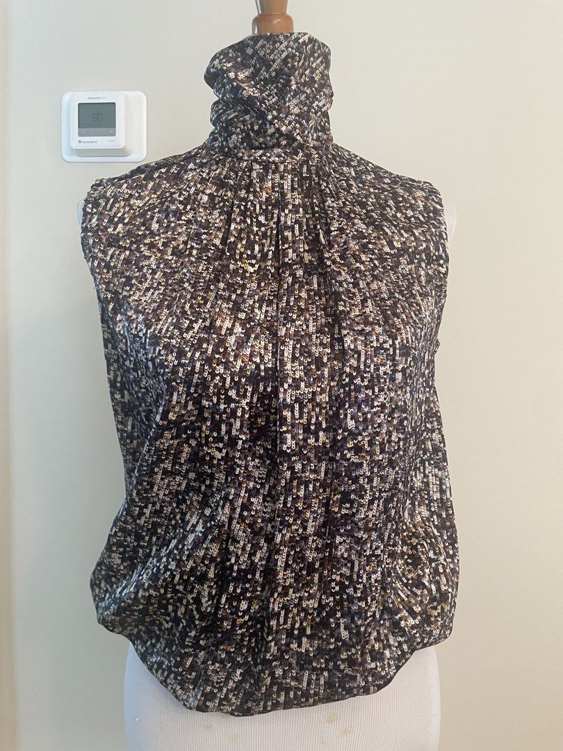 Sleeveless Mock Neck Top with Sequin-like Pattern D&G (Category: Sleeveless) located in Makati City. Submitted by cheapipie (Listing ID 1461407894, Image 1). Description: - Sleeveless mock neck top/ 100%Silk - Dark fabric with scattered sequin/bead-like pattern - Back closure - Ruched neckline detail - Versatile for dressing up or down.
