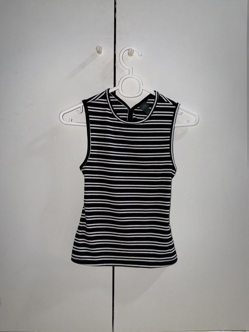 Sleeveless Wild Fable Top (Category: Sleeveless) located in Manila. Submitted by closetbykiks (Listing ID 1461425254, Image 1). Description: This ribbed knit sleeveless tank top from Wild Fable features a classic black-and-white horizontal stripe pattern with a stylish, circular open cutout design on the back. Item Details: Brand: Wild Fable Size: Extra Small (XS) Pattern: Black and white horizontal stripes Material & Texture: Stretch ribbed knit