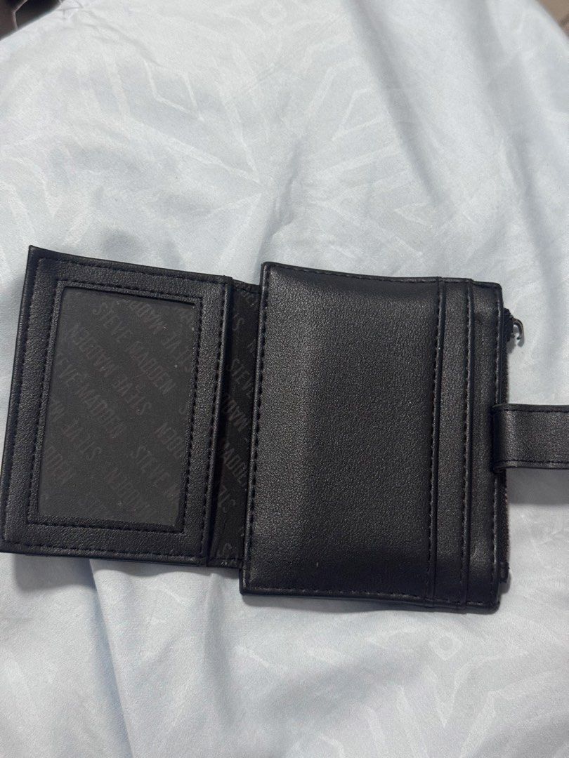 Steve Madden Black Card Holder Wallet (Category: Wallets & Card holders) located in Quezon City. Submitted by alissavio (Listing ID 1461368412, Image 3). Description: - Brand: Steve Madden - Color: Black - Type: Card Holder Wallet - Features: Multiple card slots, zippered compartment for coins - Closure: Small snap closure - Details: Embossed Steve Madden logo on front and inside lining - Benefit: Keeps cards and coins neatly organized - only iss
