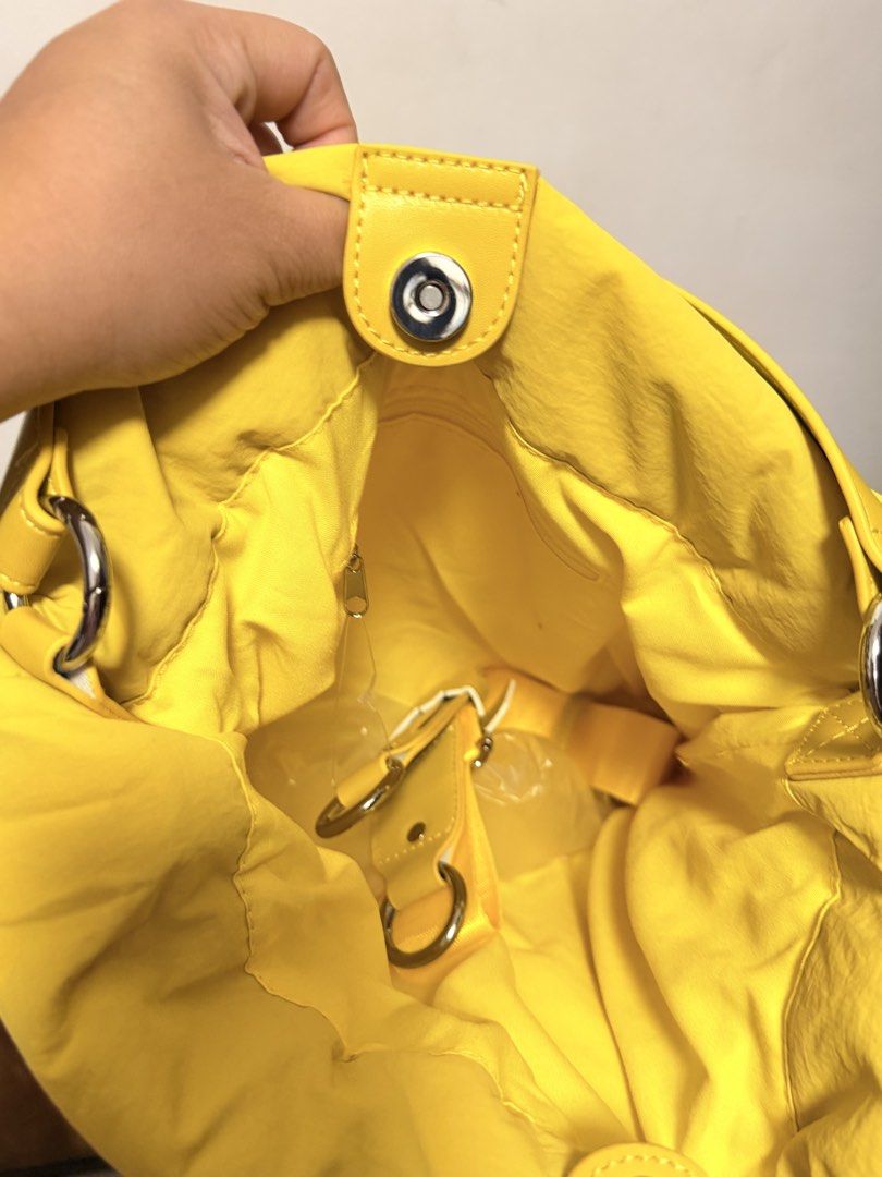 Straightforward Vero Sling Bag (Category: Shoulder Bags) located in Pasig City. Submitted by wenzwinners (Listing ID 1461366462, Image 1). Description: - Bright yellow puffer bag - Drawstring closure at the top - Front zippered pocket - Interior zippered compartment - Comfortable shoulder strap - Perfect for everyday use - Adds a vibrant pop of color to any outfit.