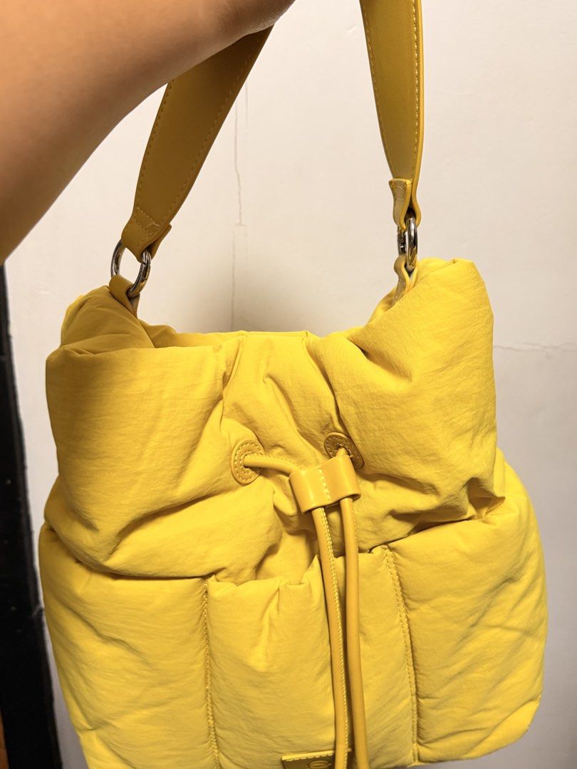 Straightforward Vero Sling Bag (Category: Shoulder Bags) located in Pasig City. Submitted by wenzwinners (Listing ID 1461366462, Image 2). Description: - Bright yellow puffer bag - Drawstring closure at the top - Front zippered pocket - Interior zippered compartment - Comfortable shoulder strap - Perfect for everyday use - Adds a vibrant pop of color to any outfit.