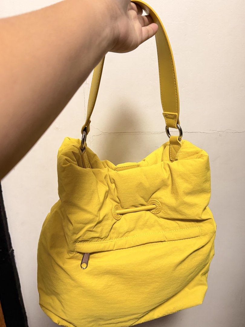 Straightforward Vero Sling Bag (Category: Shoulder Bags) located in Pasig City. Submitted by wenzwinners (Listing ID 1461366462, Image 3). Description: - Bright yellow puffer bag - Drawstring closure at the top - Front zippered pocket - Interior zippered compartment - Comfortable shoulder strap - Perfect for everyday use - Adds a vibrant pop of color to any outfit.