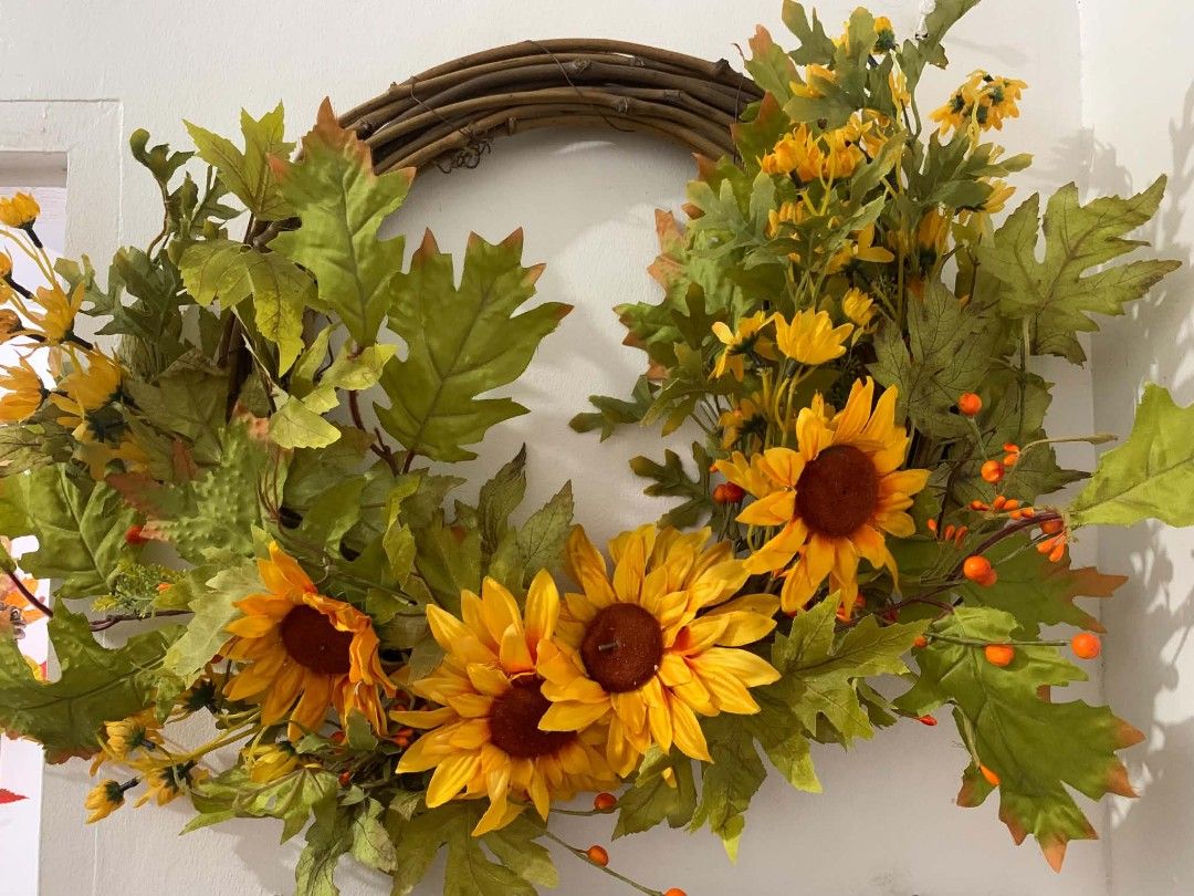 Sunflower and Leaf Wreath for Fall Decor (Category: Wall Decor) located in Quezon City. Submitted by dfabloveverything (Listing ID 1461410915, Image 1). Description: - 20 inches diameter - beautiful fall wreath featuring sunflowers, green leaves, and orange berries. - Sturdy grapevine base for durability. - Ideal for decorating your front door or wall. - Adds a warm and inviting autumnal touch to any space. - Perfect for seasonal decorating..