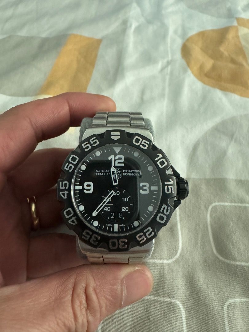 TAG Heuer Formula 1 Watch AH1010 (Category: Men's Watches) located in Caloocan City. Submitted by dave235 (Listing ID 1461464224, Image 1). Description: - Authentic TAG Heuer Formula 1 Watch - Model: AH1010 / EWT820J - Dial: Black with white markers - Band: Stainless Steel - Water Resistance: 200 meters - Crystal: Sapphire - First Owner - Includes: Original Box and Warranty Card (dated 26 Dec 2001).