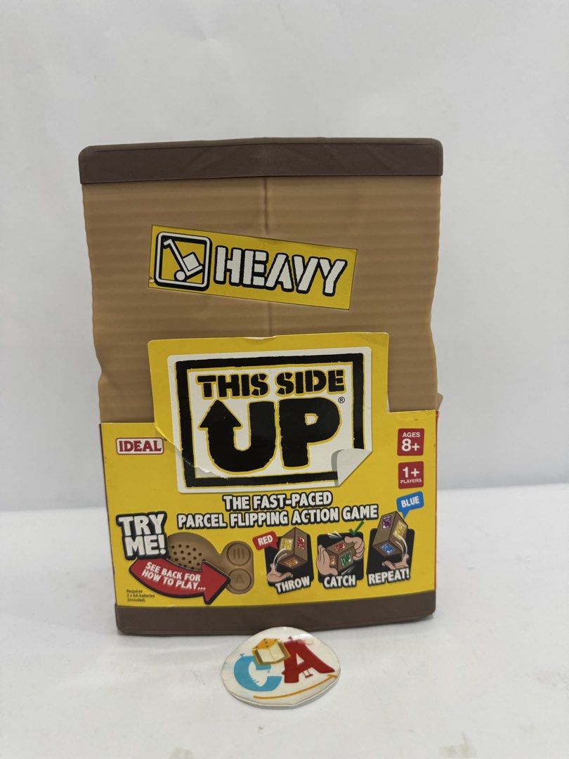 This Side Up! The Fast-Paced Parcel Flipping Action Game (Category: Board Games & Puzzles) located in Imus. Submitted by ca_readandroll (Listing ID 1461557360, Image 1). Description: - Fun parcel flipping action game - Suitable for ages 8 and up - Players throw, catch, and repeat commands - Easy to learn: press start button twice - Test your skills to keep the parcel the correct side up - Great for parties and family game nights.