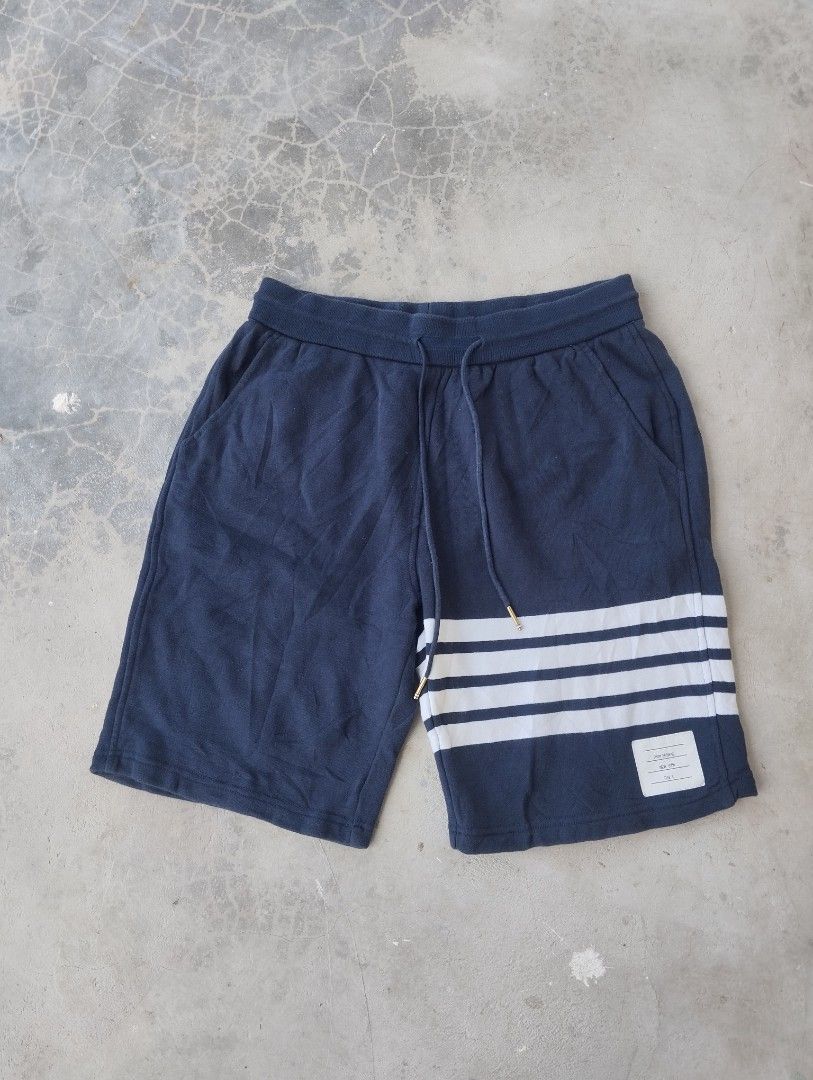 Thom Browne Navy Sweat Shorts Size 3 (Category: Shorts) located in Mati. Submitted by old_era.ph (Listing ID 1461460326, Image 2). Description: - Navy blue Thom Browne sweat shorts - Signature white stripes on the side - Made in Japan - Size 3 - Elastic waistband with drawstring - Ideal for casual wear.