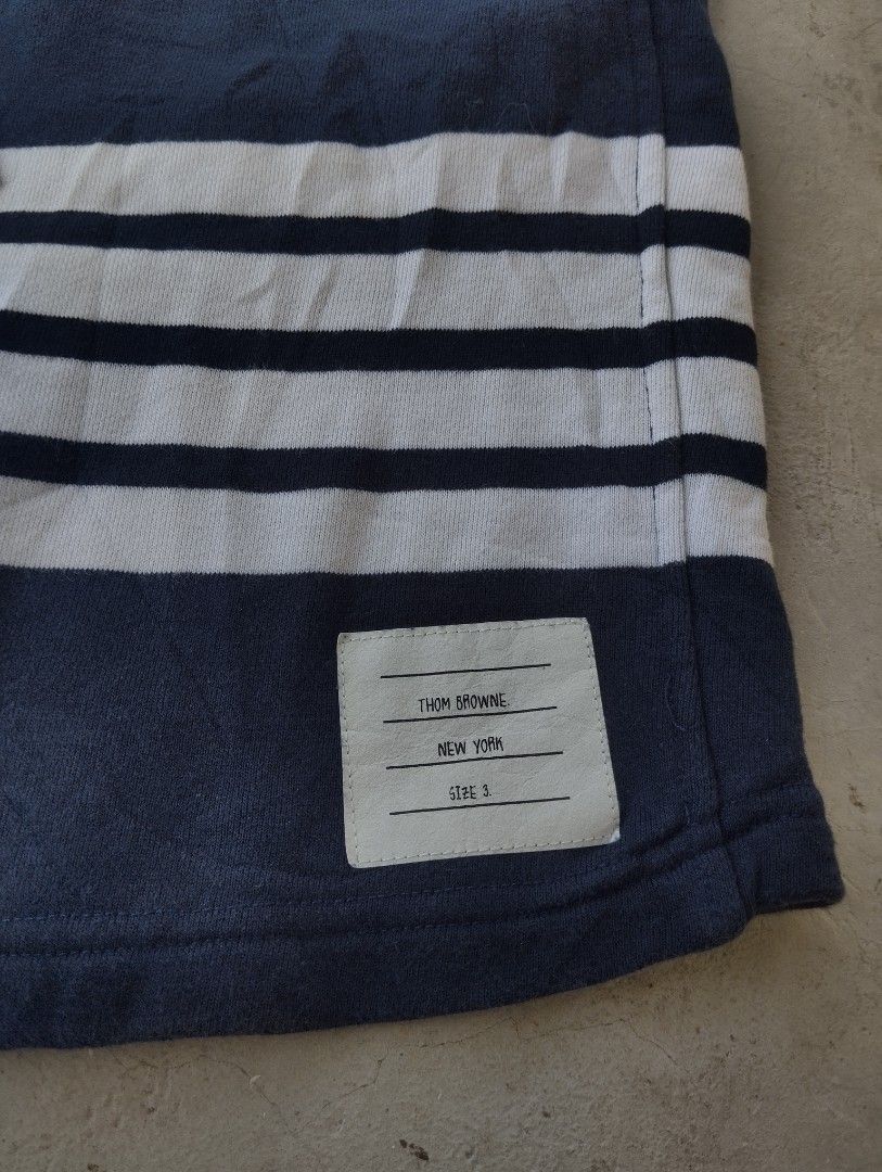 Thom Browne Navy Sweat Shorts Size 3 (Category: Shorts) located in Mati. Submitted by old_era.ph (Listing ID 1461460326, Image 3). Description: - Navy blue Thom Browne sweat shorts - Signature white stripes on the side - Made in Japan - Size 3 - Elastic waistband with drawstring - Ideal for casual wear.