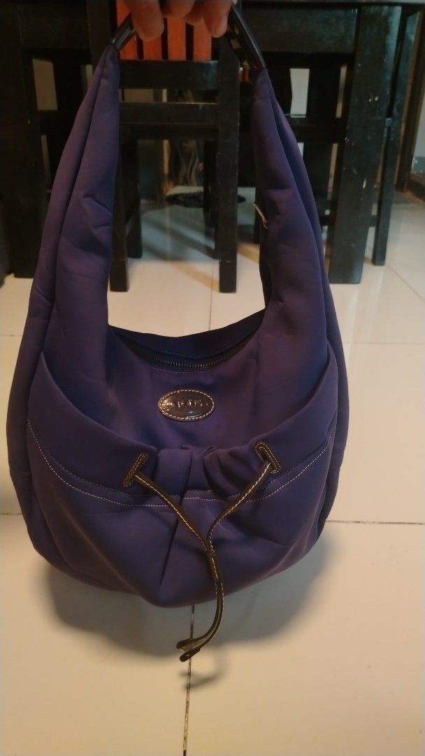 TOD'S Purple Nylon Drawstring Hobo Bag (Category: Luxury Bags & Wallets) located in Manila. Submitted by wildwind_73f77a (Listing ID 1461489291, Image 1). Description: - Brand: TOD'S - Style: Hobo Bag - Color: Purple - Material: Nylon with Leather Trim - Closure: Drawstring on front pocket - Hardware: Silver - Features: Spacious interior, great for everyday use.