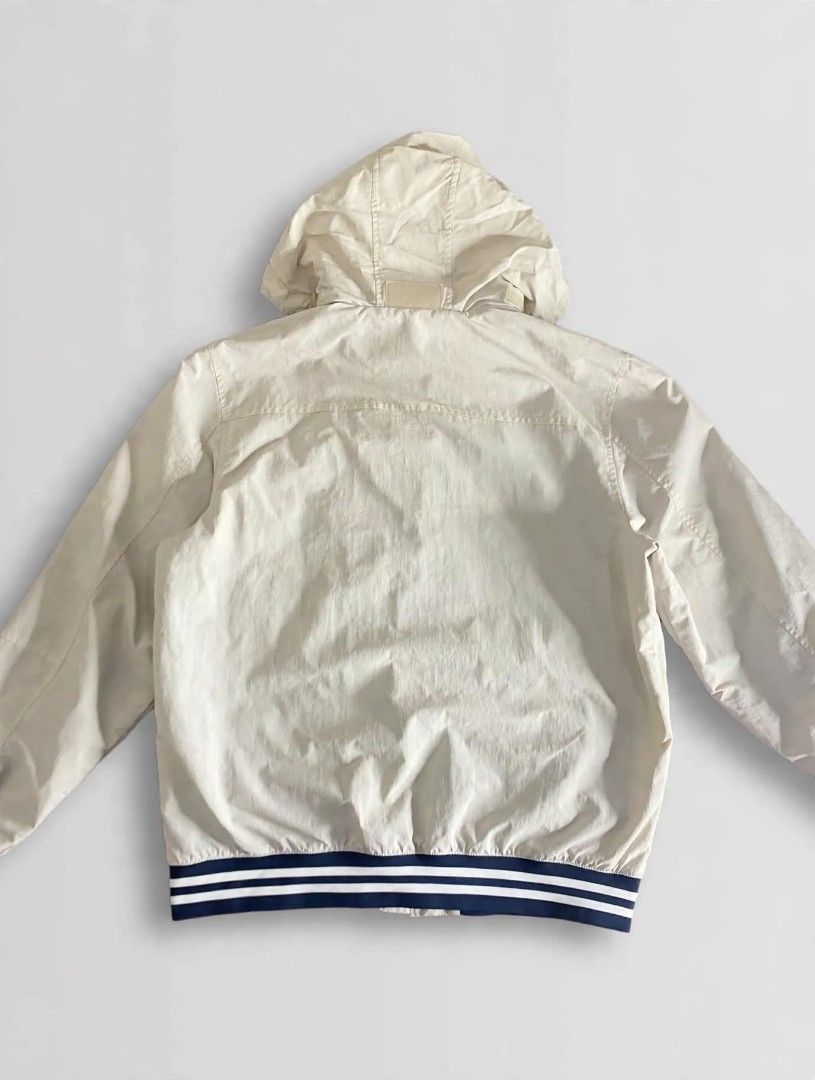 Tommy Hilfiger Beige Hooded Bomber Jacket (Category: Coats, Jackets and Outerwear) located in Bansalan. Submitted by thriftyzzz (Listing ID 1461474021, Image 3). Description: - Tommy Hilfiger beige jacket - Zip-up front with a hidden hood - Ribbed cuffs and hem with navy and white stripes - Two front pockets - Tommy Hilfiger logo on the chest - Ideal for casual wear.