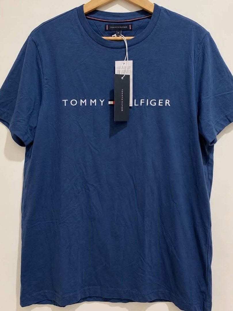 Tommy Hilfiger Blue T-Shirt (Category: Tshirts & Polo Shirts ) located in Davao. Submitted by akushhla (Listing ID 1461476762, Image 1). Description: - Authentic Tommy Hilfiger T-shirt - Color: Blue - Features the classic Tommy Hilfiger logo across the chest - Available on hand .