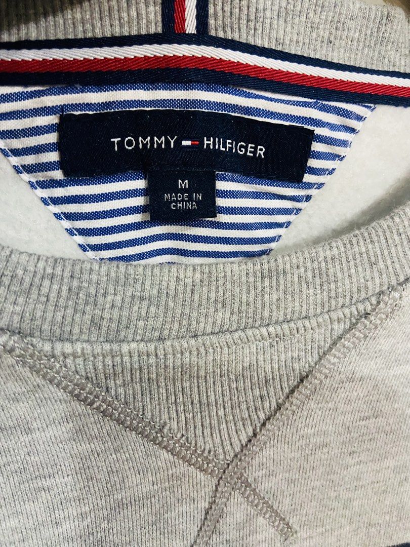 Tommy Hilfiger Grey Crewneck Sweatshirt (Category: Coats, Jackets and Outerwear) located in Manila. Submitted by thriftnijuan08 (Listing ID 1461340356, Image 3). Description: - Grey Tommy Hilfiger sweatshirt - Size: Medium (M) - Features classic Tommy flag logo on the front - Made in China - Ideal for casual everyday wear -Dimes 22/25.