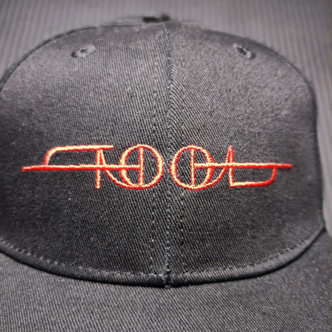 Tool official band cap (Category: Caps & Hats) located in Manila. Submitted by nye.seller (Listing ID 1461494733, Image 2). Description: - Black baseball cap featuring the iconic Tool logo embroidered in vibrant red. - Adjustable snapback closure for a comfortable, custom fit. - Officially licensed merchandise from Rock Off. - Brand new with tags still attached. - Made in China..