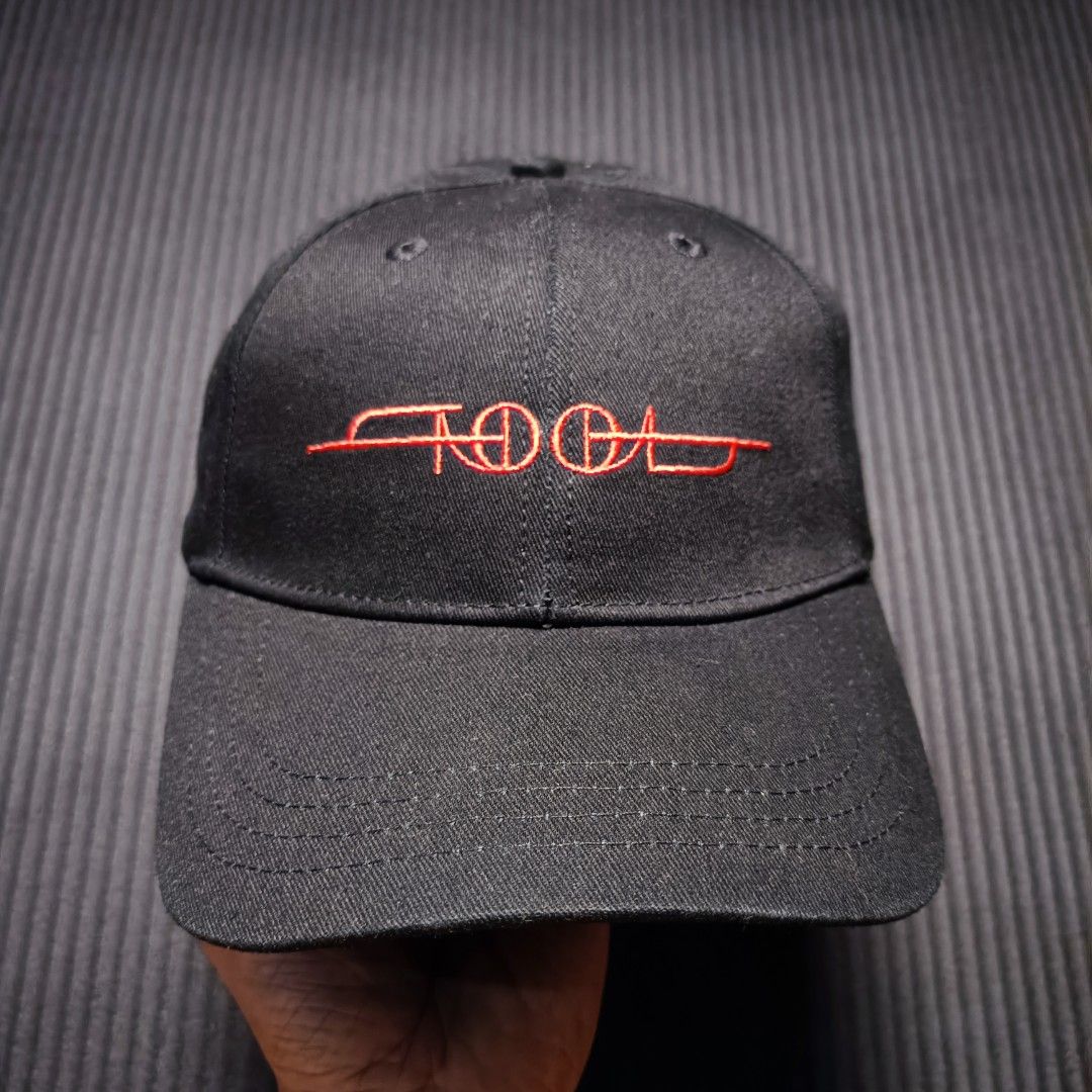 Tool official band cap (Category: Caps & Hats) located in Manila. Submitted by nye.seller (Listing ID 1461494733, Image 1). Description: - Black baseball cap featuring the iconic Tool logo embroidered in vibrant red. - Adjustable snapback closure for a comfortable, custom fit. - Officially licensed merchandise from Rock Off. - Brand new with tags still attached. - Made in China..