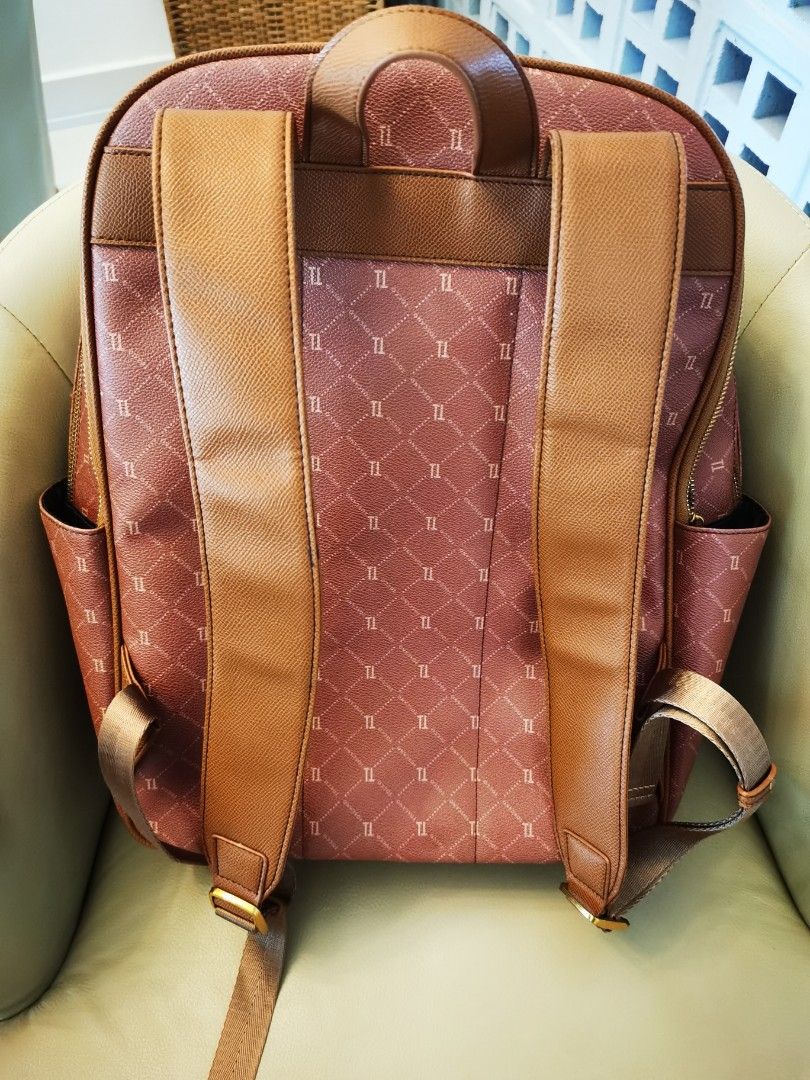 TOSCANO Monogram Backpack (Category: Backpacks) located in Johor Bahru. Submitted by livewater-1a4c (Listing ID 1461417432, Image 2). Description: - Dusty rose Toscano monogram backpack - Brown trim and straps - Front zip pocket - Side pockets - Gold hardware - Adjustable shoulder straps - Approximately 15 inches tall.