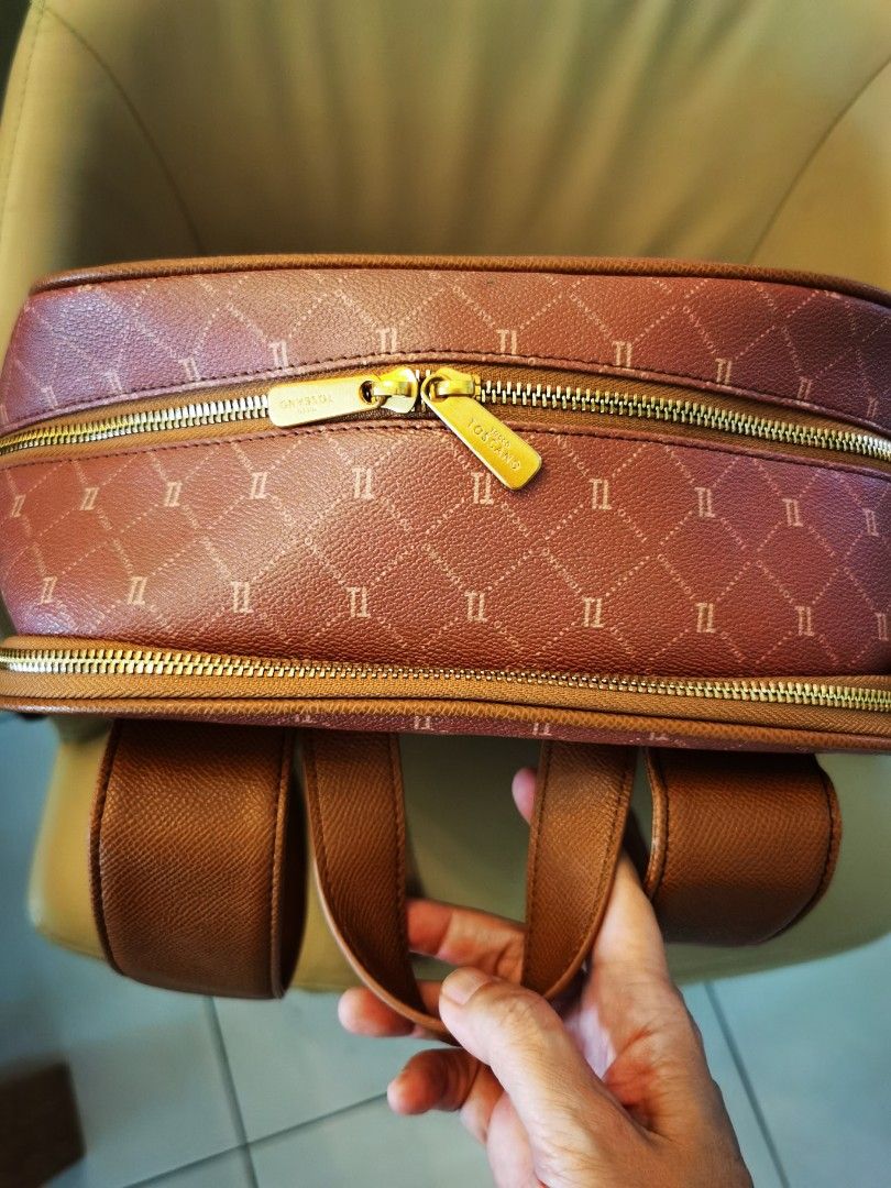 TOSCANO Monogram Backpack (Category: Backpacks) located in Johor Bahru. Submitted by livewater-1a4c (Listing ID 1461417432, Image 3). Description: - Dusty rose Toscano monogram backpack - Brown trim and straps - Front zip pocket - Side pockets - Gold hardware - Adjustable shoulder straps - Approximately 15 inches tall.
