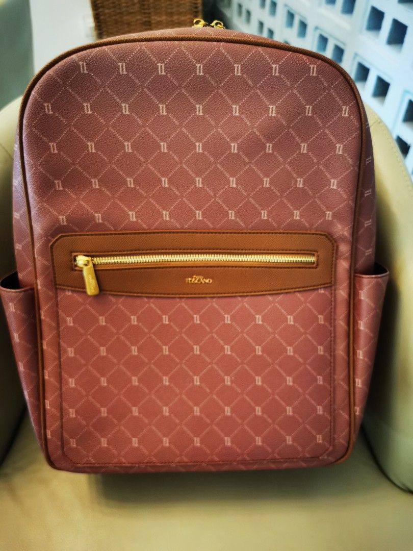 TOSCANO Monogram Backpack (Category: Backpacks) located in Johor Bahru. Submitted by livewater-1a4c (Listing ID 1461417432, Image 1). Description: - Dusty rose Toscano monogram backpack - Brown trim and straps - Front zip pocket - Side pockets - Gold hardware - Adjustable shoulder straps - Approximately 15 inches tall.