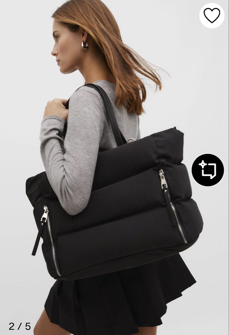 Tote bag (Category: Tote Bags) located in Pototan. Submitted by tres_190725 (Listing ID 1461512885, Image 2). Description: This item is the Stradivarius Tote Bag with Zips in black. It is a popular, lightweight utility travel shopper bag from the brand Stradivarius, constructed from a smooth nylon/polyamide fabric. It features a distinctive horizontal padded panel construction, thin twin shoulder straps, and prominent vertical zippers on the fron