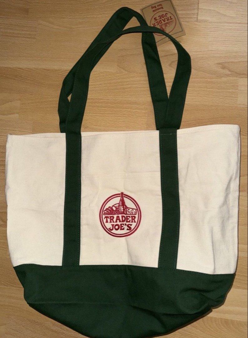 Trader Joe's Reusable Tote Bag (Category: Tote Bags) located in Subic. Submitted by malojod2334612 (Listing ID 1461372862, Image 1). Description: - Classic Trader Joe's canvas tote bag - Cream color with dark green bottom and handles - Features iconic Trader Joe's embroidered logo - Ideal for groceries or everyday use - Durable and reusable design.