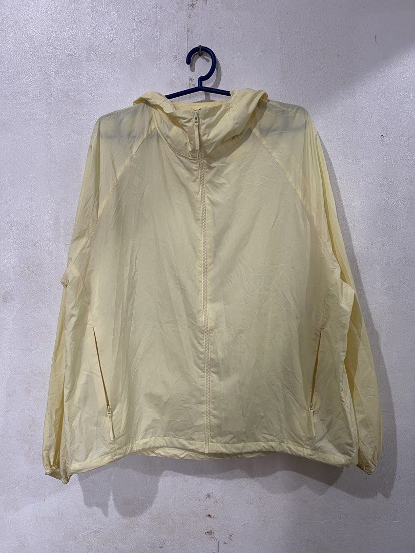 Uniqlo Pocketable Light Yellow Hooded Jacket (Category: Coats, Jackets and Outerwear) located in Makati City. Submitted by vertaronda2 (Listing ID 1461389628, Image 1). Description: 23” x24” Medium - Lightweight yellow windbreaker from Uniqlo - Features a hood with adjustable drawstring - Full zip front closure - Two side pockets with zippers - Perfect for layering or light protection - Easy to pack and carry.