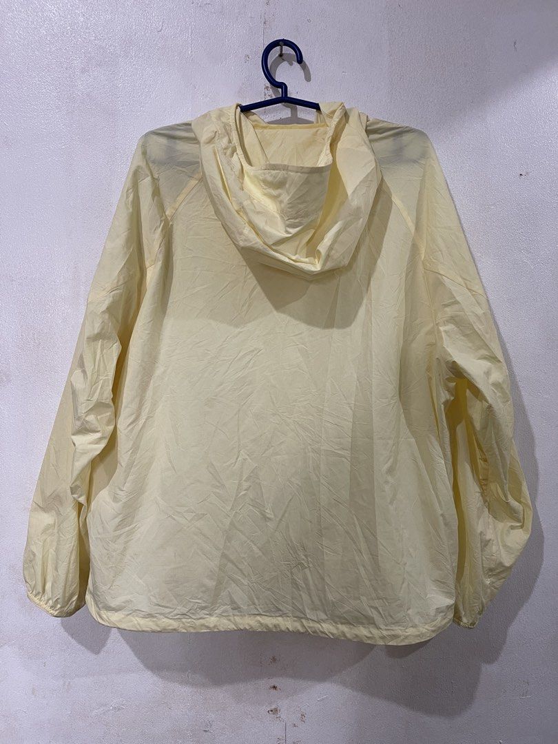 Uniqlo Pocketable Light Yellow Hooded Jacket (Category: Coats, Jackets and Outerwear) located in Makati City. Submitted by vertaronda2 (Listing ID 1461389628, Image 3). Description: 23” x24” Medium - Lightweight yellow windbreaker from Uniqlo - Features a hood with adjustable drawstring - Full zip front closure - Two side pockets with zippers - Perfect for layering or light protection - Easy to pack and carry.