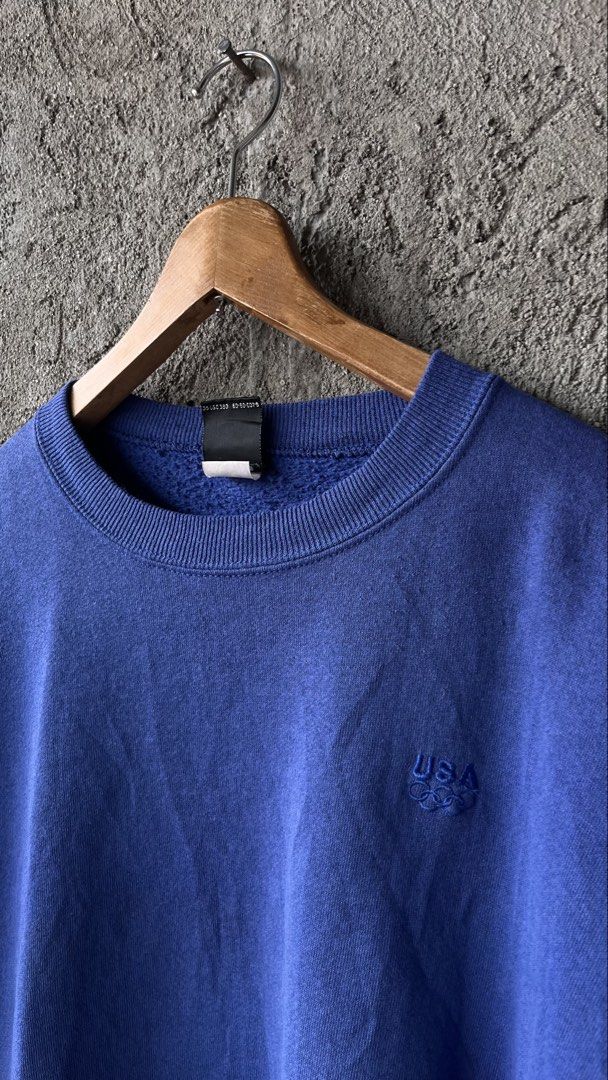 USA Olympic Crewneck Sweatshirt (Category: Coats, Jackets and Outerwear) located in Cabuyao City. Submitted by bulandos (Listing ID 1461428170, Image 2). Description: - Blue crewneck sweatshirt - Features official USA Olympic branding - Embroidered Olympic rings logo on chest - Made for the USA Olympic team - Exclusive JCPenney retail item - Ideal for sports enthusiasts and collectors.