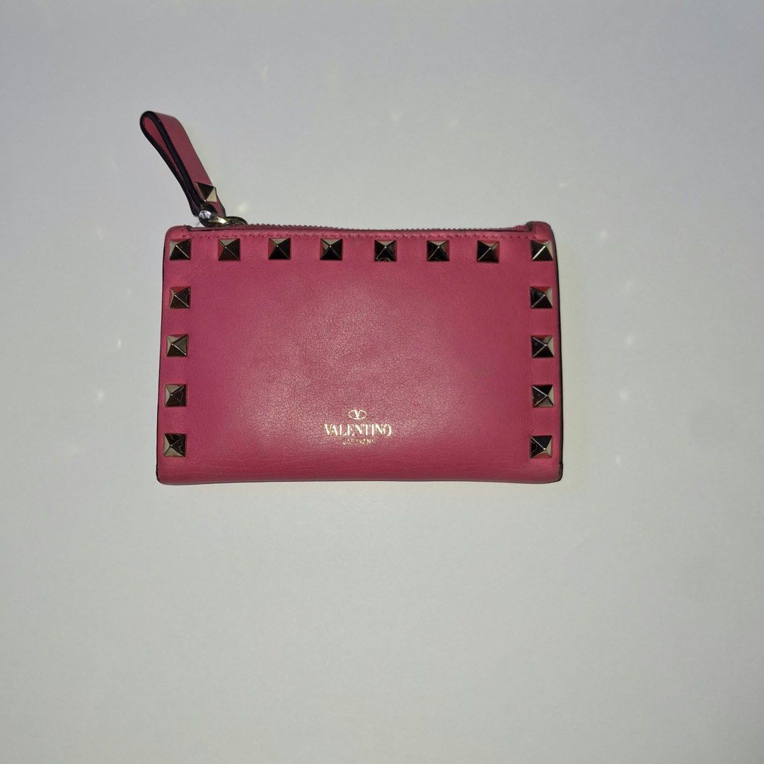 Valentino Pink Studded Leather Wallet (Category: Luxury Bags & Wallets) located in Manila. Submitted by Mimi020623 (Listing ID 1461345924, Image 1). Description: - Authentic Pink Valentino Wallet - Genuine Leather with Signature Stud Details - Secure Zipper Closure - Interior Card Slots and Snap Button Compartment - Made in Italy - Approximate Dimensions: 4.5 x 3.5 inches.
