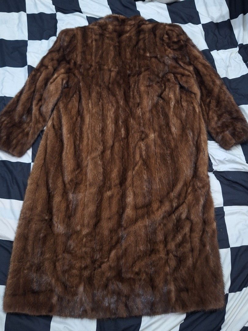 Vintage Brown Mink Fur Long Coat (Category: Coats, Jackets and Outerwear) located in Puerto Princesa. Submitted by jercksthriftph (Listing ID 1461381245, Image 2). Description: - Elegant long brown fur coat, with a luxurious mink-like appearance. - Smooth satin lining for added comfort. - Includes a stylish tie belt for a customizable fit. - Features a wide, statement collar. - Full-length sleeves provide complete coverage. - Ideal for keeping wa