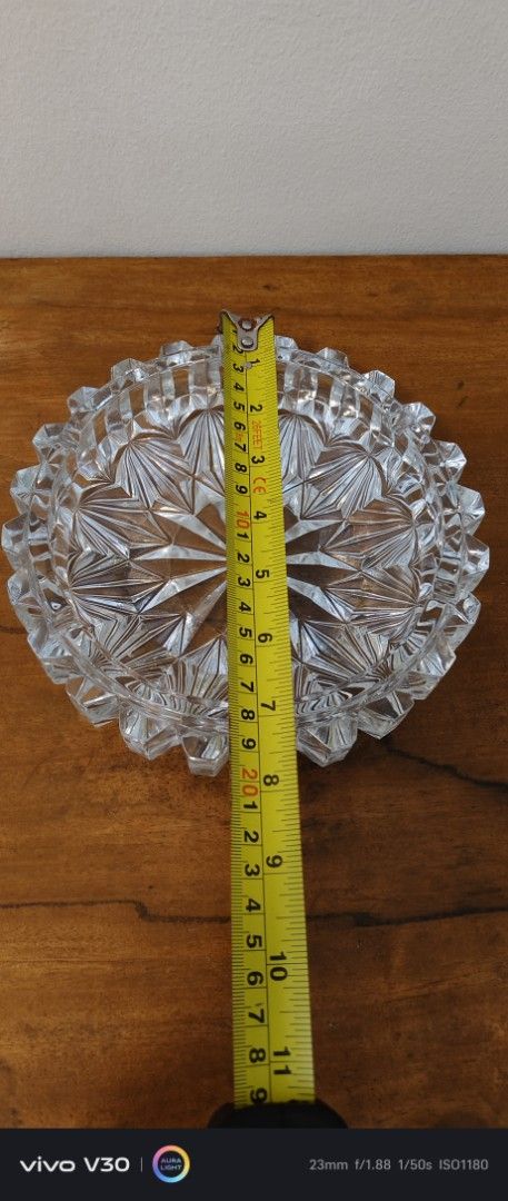Vintage Crystal Glass Ashtray (Category: Other Home Decor) located in Manila. Submitted by roblazo25 (Listing ID 1461379692, Image 3). Description: - Heavy crystal glass ashtray - Features an intricate starburst pattern in the center - Scalloped, cut-glass edge for added elegance - Measures approximately 6 inches in diameter - Perfect for coffee tables or as a decorative accent - No chips or cracks observed.
