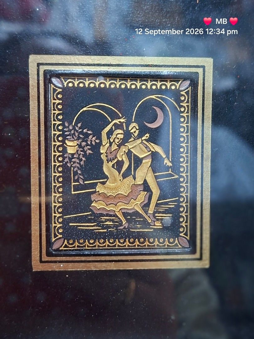 Vintage Framed Artwork with Couple Dancing (Category: Frames & Pictures) located in Lucena. Submitted by dai_suki (Listing ID 1461336341, Image 2). Description: - Small framed artwork featuring a couple dancing. - Elegant black and gold frame with intricate patterns. - Artwork has a unique metallic sheen. - Dimensions: Approximately 6 inches by 6 inches. - Ideal as a gift or for personal art collection..