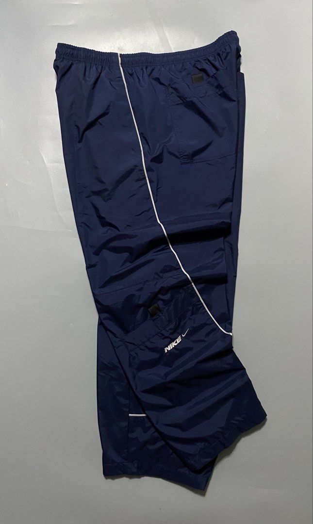 Vintage nike trackpants (Category: Joggers) located in Manila. Submitted by delunakenn94368 (Listing ID 1461537769, Image 3). Description: - Navy blue Nike track pants - Size XXL - Elastic waistband with drawstring - Two side pockets and two back pockets - White piping detail along the sides - Ideal for sports or casual wear.