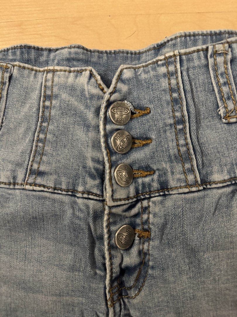 Vivienne Westwood Short (Category: Shorts) located in Manila. Submitted by juhjuh (Listing ID 1461381136, Image 2). Description: - Cute light wash denim shorts - High-waisted fit (25/26) - Button-up front closure - Unique criss-cross detail at the back waistband - Distressed pocket details - Ideal for casual wear.