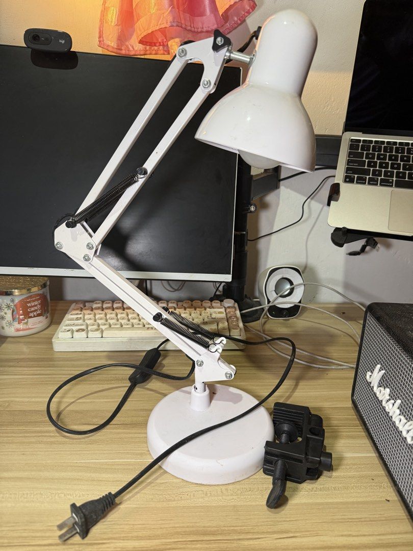 White Adjustable Desk Lamp with Clamp (Category: Lighting) located in Tuguegarao City. Submitted by janurtist (Listing ID 1461492109, Image 1). Description: - White adjustable desk lamp - Flexible arm with springs for easy positioning - Clamp attachment for secure mounting - Visible bulb inside shade - Includes power cord and switch - Ideal for study or work areas Selling Price: 350 pesos J&T Loc: Abulug, Cagayan.