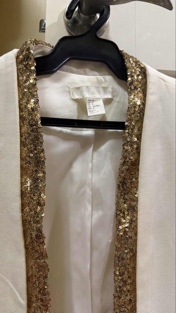 Cream Blazer Lined With Gold Sequins (Category: Coats, Jackets and Outerwear) located in San Juan City. Submitted by kassyjsn (Listing ID 1461533417, Image 2). Description: - Brand: H&M - Item: Cream Blazer - Design: Lined with shimmering gold sequins - Size: Medium (EU 38 / UK 10 / US 6) - Perfect for adding a glamorous touch to any outfit - Price is negotiable :).