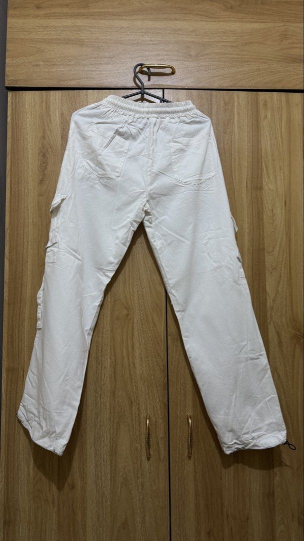 White Cargo Pants with Drawstring Waist (Category: Other Bottoms) located in Taguig. Submitted by chaebrulee (Listing ID 1461437872, Image 2). Description: - White cargo pants - Elastic waistband with drawstring - Multiple pockets on front and sides - Adjustable drawstring at ankles Small to Medium Waist.