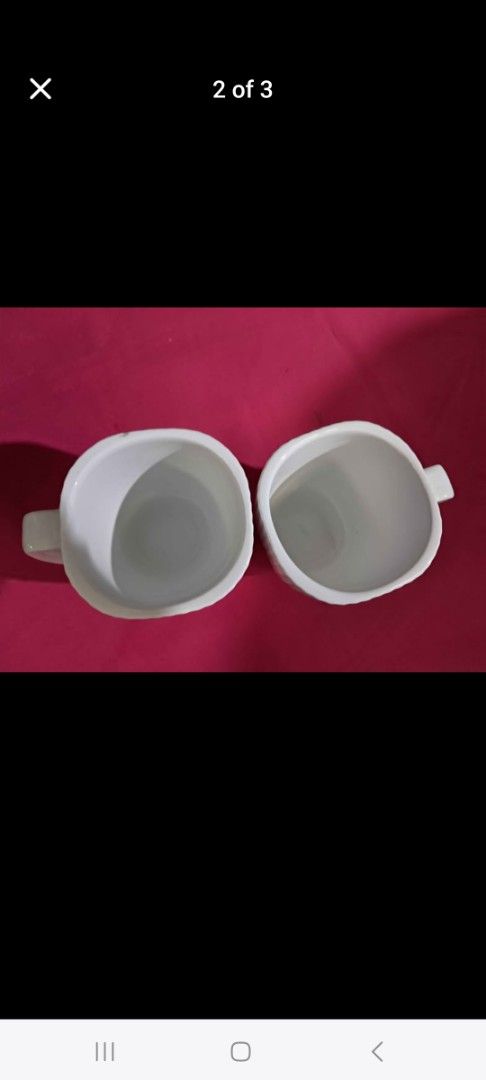 White Ceramic Couple Mugs (Category: Coffee & Tea Tableware) located in Cainta. Submitted by ceejay.lim (Listing ID 1461462513, Image 3). Description: - Set of 2 white ceramic mugs - Features a stylish ribbed texture - Ideal for coffee, tea, or any hot beverage - Dishwasher and microwave safe for convenience - Great for everyday use or as a thoughtful gift.