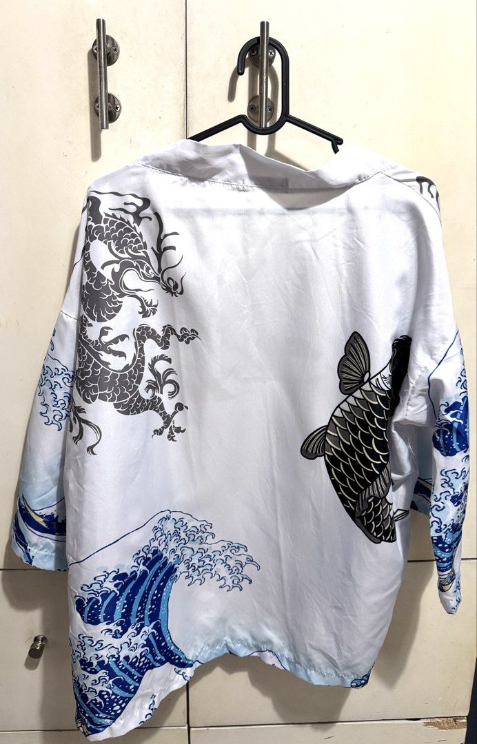 White Dragon Koi Wave Kimono Jacket (Category: Coats, Jackets and Outerwear) located in Mandaluyong City. Submitted by spaceshipshop (Listing ID 1461462960, Image 2). Description: - Unique white kimono jacket - Features a striking dragon and koi fish print - Sleeve and hem detail with wave patterns - Lightweight material, ideal for layering - Open front style for easy wear.